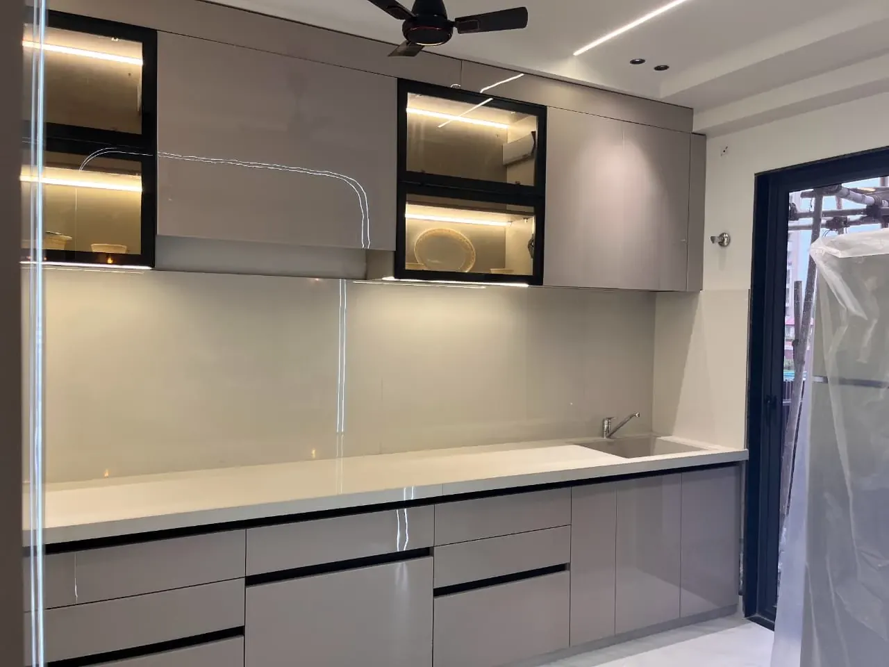 Fitted kitchen counter and upper cabinets in a completed home, photographed on site — Aerovista, Jaipur